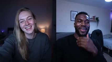 Two people in separate rooms at night, each smiling at their screen.